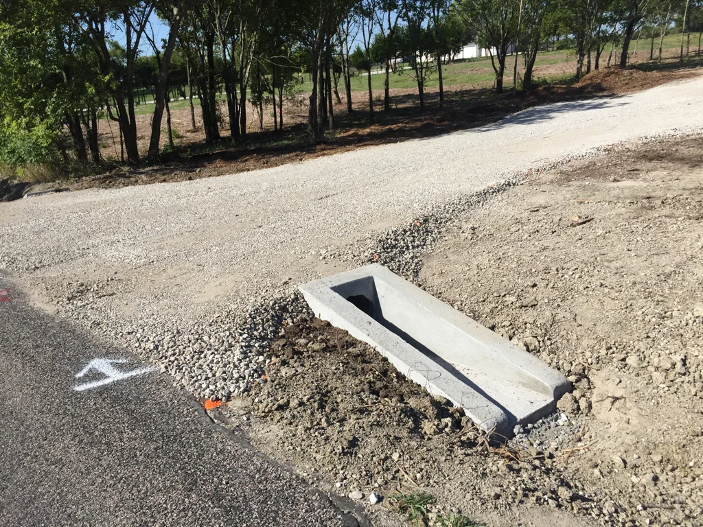Finished gravel driveway entrance with concrete culvert end section in South Alabama
