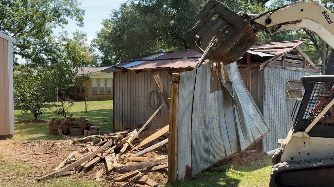 Excavator taking down an old structure during demolition
