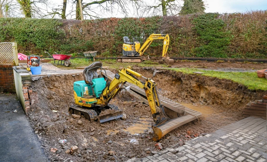 Excavator digging a foundation footing on a homesite near Spanish Fort, AL