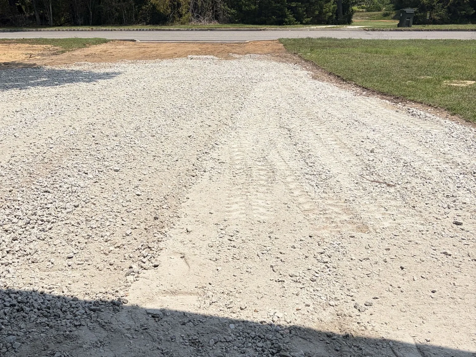 New gravel driveway freshly spread and tied into the road, an EMCO Builders job